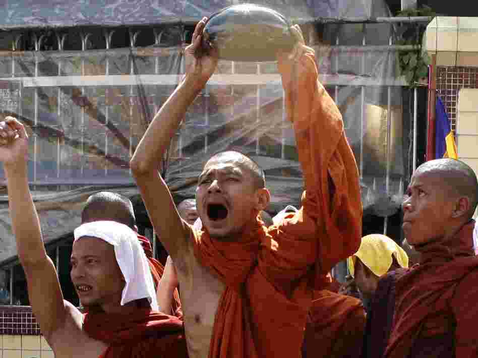 A monk waves his alms bowl upside down in defiance of a threat to send troops to end anti-junta protests in Yangon on Sept. 25, 2007, during the country's monk-led Saffron Revolution.