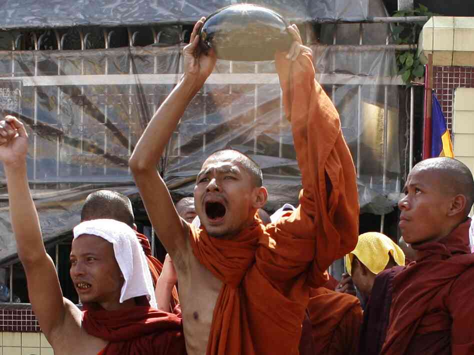 A monk waves his alms bowl upside down in defiance of a threat to send troops to end anti-junta protests in Yangon on Sept. 25, 2007, during the country's monk-led Saffron Revolution.
