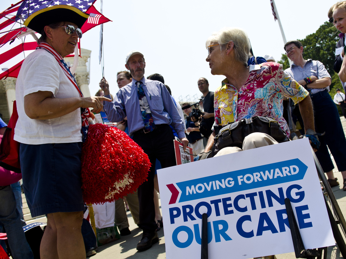 Susan Clark (left) argues with another protester about the Affordable Care Act outside the U.S. Supreme Court on Thursday.