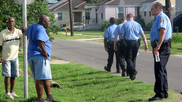 Sgt. Miro Brekalo talks with residents in New Orleans' Gentilly neighborhood, as other officers walk their beat. Their goal isn't only to stop crime; it's also to connect with citizens who are often reluctant to report crimes.