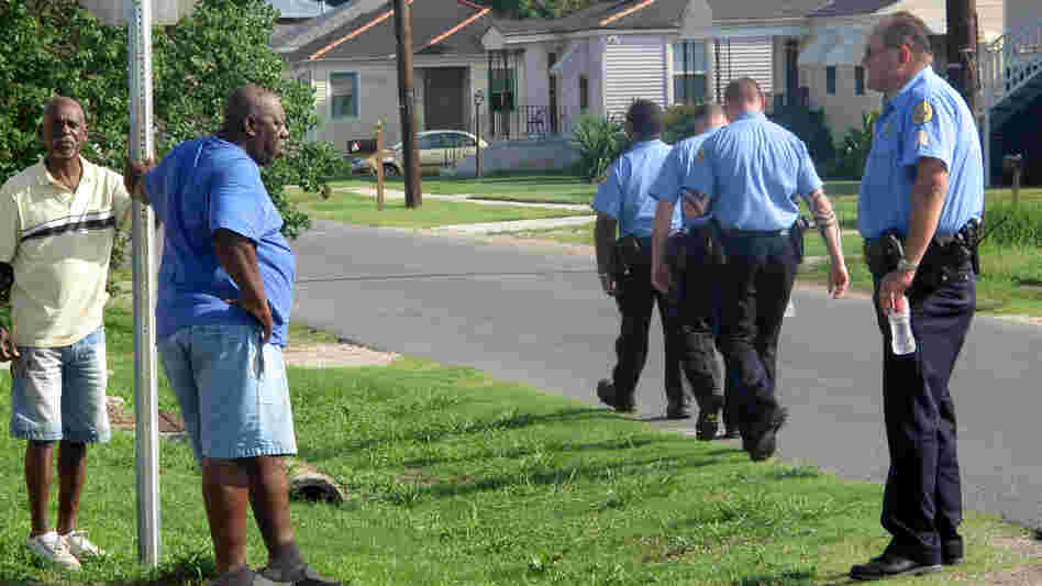 Sgt. Miro Brekalo talks with residents in New Orleans' Gentilly neighborhood, as other officers walk their beat. Their goal isn't only to stop crime; it's also to connect with citizens who are often reluctant to report crimes.