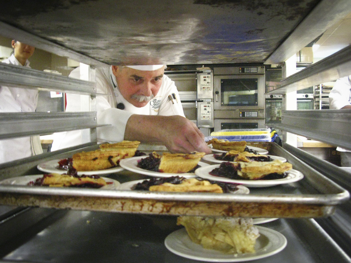 CIA Instructor George Higgins checks the slices of pie made by students.