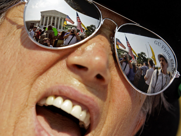 A demonstrator protests outside the the Supreme Court Thursday in Washington, D.C.