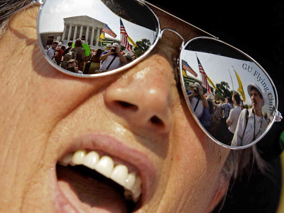 A demonstrator protests outside the the Supreme Court Thursday in Washington, D.C.
