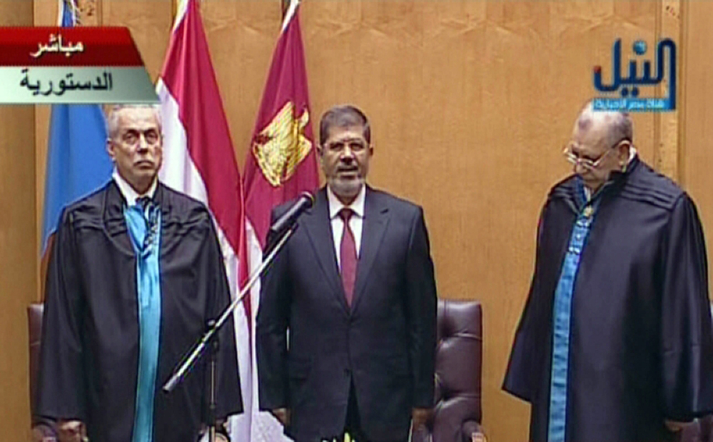 An image grab taken from Egypt's Nile TV shows Egyptian President Mohamed Morsi (center) taking the oath of office during the official swearing-in ceremony at the Constitutional Court in Cairo on Saturday.