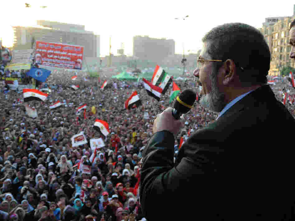 In this handout picture made available by the Egyptian presidency, Egypt's Islamist president-elect Mohamed Morsi addresses tens of thousands of Egyptians in Cairo's iconic Tahrir Square on Friday.