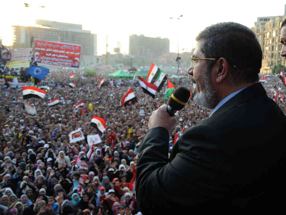 In this handout picture made available by the Egyptian presidency, Egypt's Islamist president-elect Mohamed Morsi addresses tens of thousands of Egyptians in Cairo's iconic Tahrir Square on Friday.