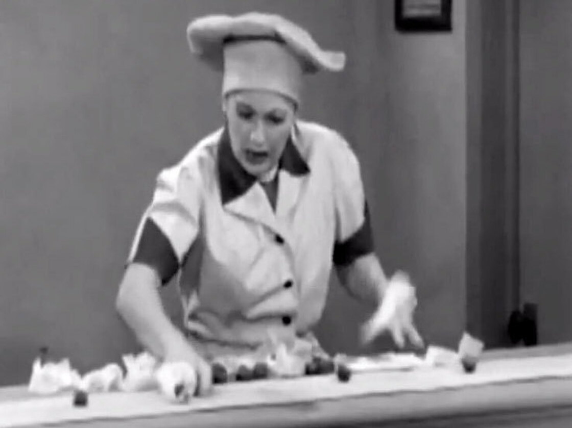 In a famous scene from I Love Lucy, Lucille Ball fights a losing battle.