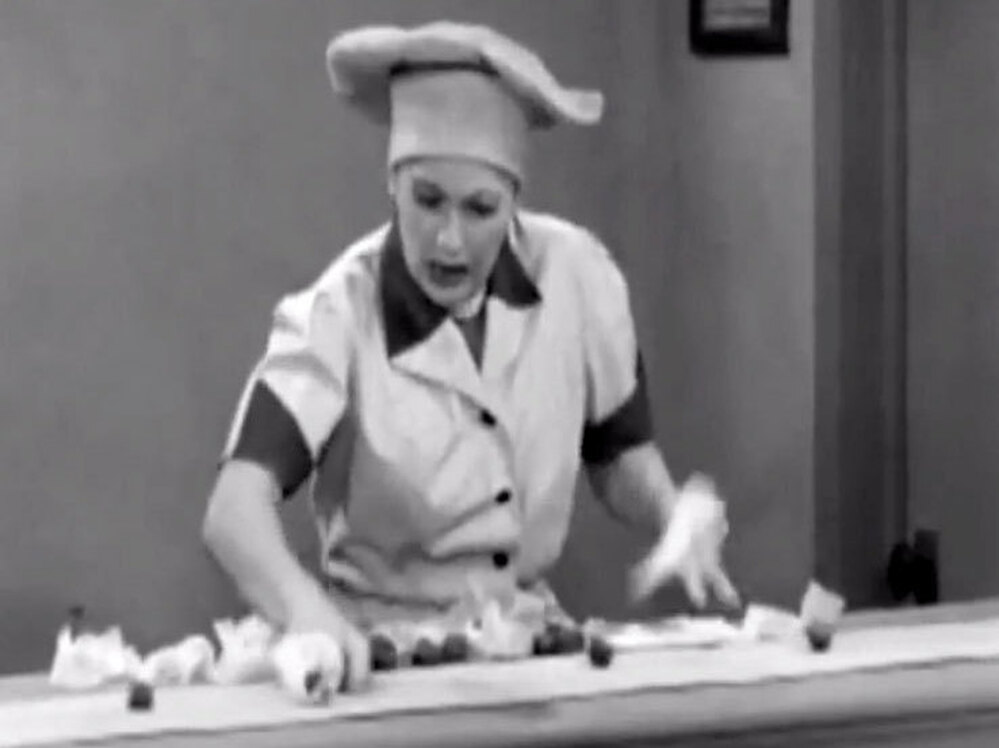 In a famous scene from I Love Lucy, Lucille Ball fights a losing battle.