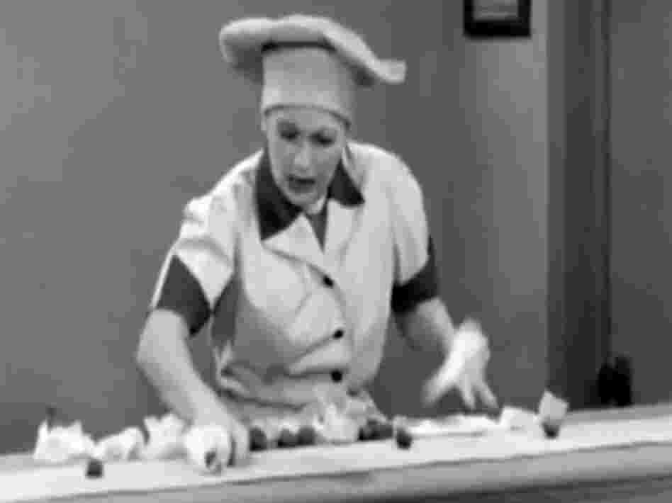 In a famous scene from I Love Lucy, Lucille Ball fights a losing battle.