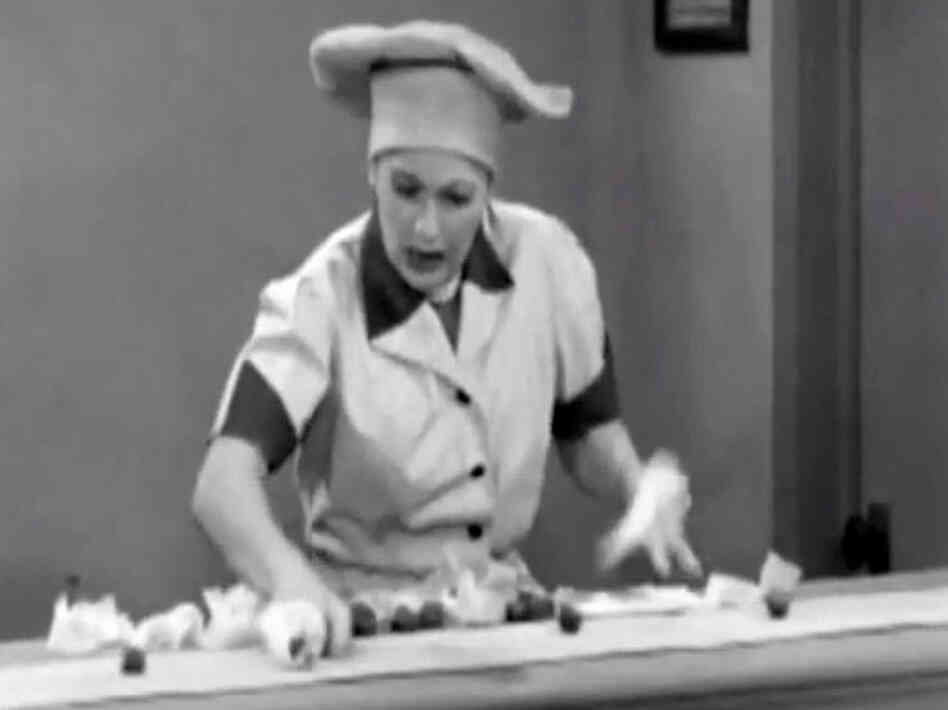 In a famous scene from I Love Lucy, Lucille Ball fights a losing battle.