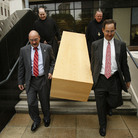 Deacon Mark Coudrain, bottom left, Rev. Charles Benoit, top left, Abbot Justin Brown, top right, and attorney Evans Schmidt carry a casket built by Benedictine monks down the steps of the U.S. federal district courthouse on Aug. 12, 2010. Deacon Mark Coudrain, bottom left, Rev. Charles Benoit, top left, Abbot Justin Brown, top right, and attorney Evans Schmidt carry a casket built by Benedictine monks down the steps of the U.S. federal district courthouse on Aug. 12, 2010.