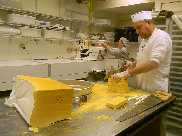 Candy maker Tim Leahy saws a block of sponge candy down to bite-size.
