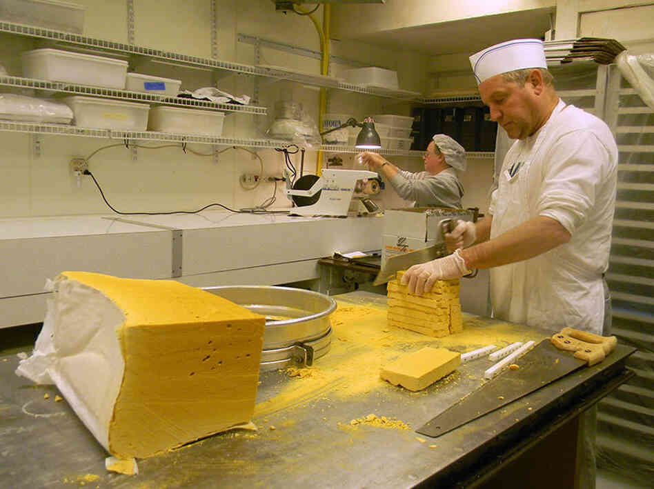 Candy maker Tim Leahy saws a block of sponge candy down to bite-size.