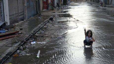 A handout image released by the Syrian opposition's Shaam News Network on Monday shows a girl flashing the sign for victory in a destroyed street flooded with water in the restive central city of Homs. A handout image released by the Syrian opposition's Shaam News Network on Monday shows a girl flashing the sign for victory in a destroyed street flooded with water in the restive central city of Homs.