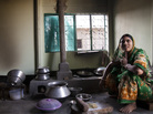 A woman at home in Bangladesh with an improved cookstove A woman at home in Bangladesh with an improved cookstove