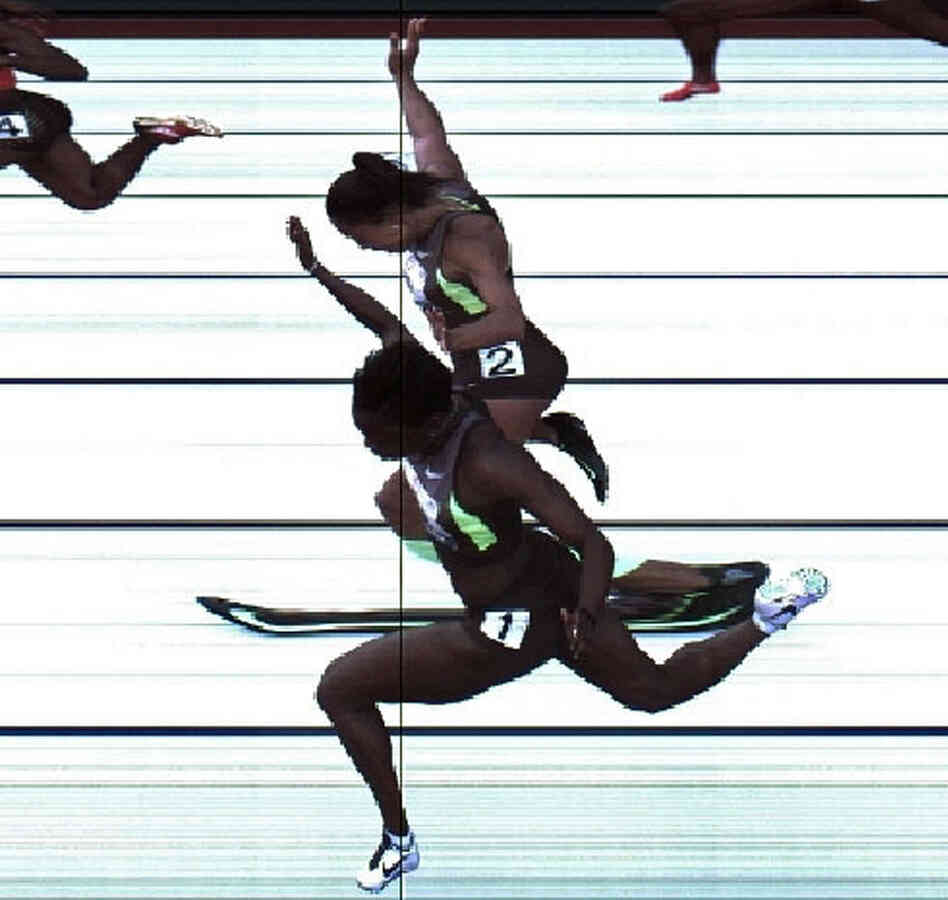In this handout photo provided by the USATF, Jeneba Tarmoh (bottom, lane 1) and Allyson Felix cross the finish line at exactly the same time in the women's 100 meter dash final during Day Two of the 2012 U.S. Olympic Track & Field Team Trials at Hayward Field on June 23 in Eugene, Ore. It's their torsos, not head, hands, feet or arms, that matter.