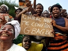 Supporters of Ivorian president Laurent Gbagbo wave upon his departure for France January 23, 2003 at Abidjan airport. Gbagbo now resides in The Hague, awaiting trial on charges of crimes against humanity during conflicts with rebels in the West African nation. Supporters of Ivorian president Laurent Gbagbo wave upon his departure for France January 23, 2003 at Abidjan airport. Gbagbo now resides in The Hague, awaiting trial on charges of crimes against humanity during conflicts with rebels in the West African nation.