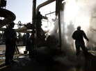 Iranian workers make repairs to a unit at Tehran's oil refinery in November 2007. It's estimated that a Western oil embargo is costing Iran about $4.5 billion each month in lost revenue. Iranian workers make repairs to a unit at Tehran's oil refinery in November 2007. It's estimated that a Western oil embargo is costing Iran about $4.5 billion each month in lost revenue.