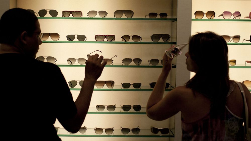 Brazilian shoppers try on sunglasses at a store in Fort Lauderdale, Fla., in March.