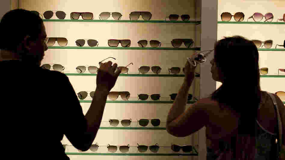 Brazilian shoppers try on sunglasses at a store in Fort Lauderdale, Fla., in March.