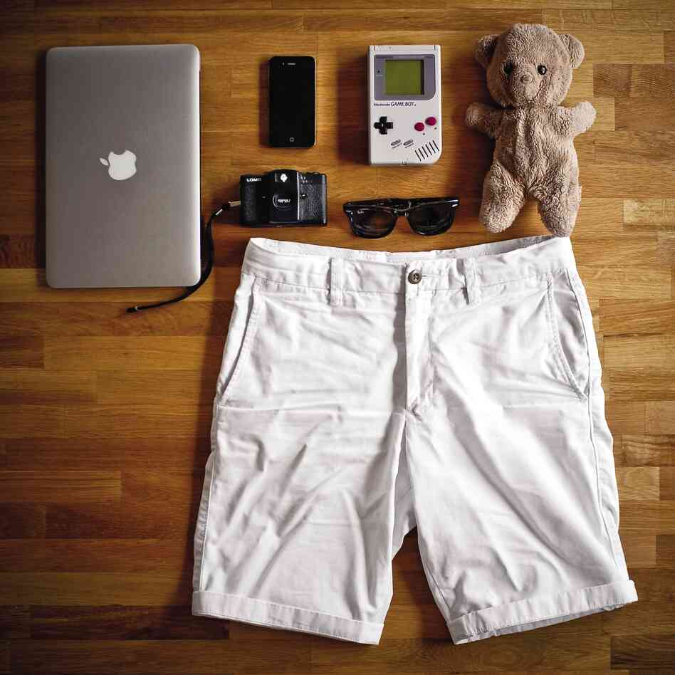 Will Cheyney, 27, London, design director: "11" MacBook Air, Eddy the Teddy, Nintendo Game Boy, Ray-Ban folding Wayfarers, iPhone 4, white chino shorts, Lomo LC-A camera."