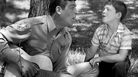 Andy Griffith as Sheriff Andy Taylor and Ron Howard as his son, "Opie" Taylor sing together in 1962. Andy Griffith as Sheriff Andy Taylor and Ron Howard as his son, "Opie" Taylor sing together in 1962.