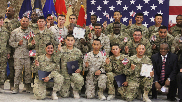 U.S. soldiers and Marines pose after being sworn in as U.S. citizens in a service at Kandahar Air Field in Afghanistan on Friday.