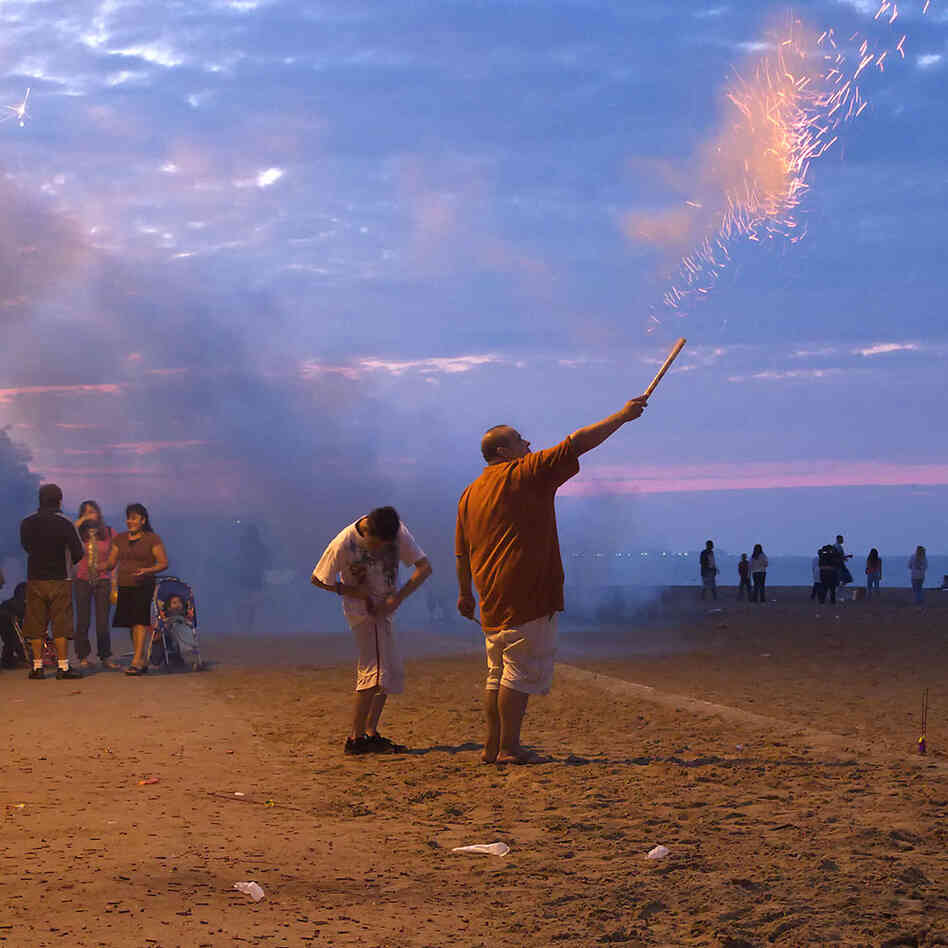 Roman Candle. Chicago. On the night of independence at the beach in my Rogers Park neighborhood in Chicago, the locals come out with their stashes of fireworks purchased in Indiana and Wisconsin and put on their own show on the Lake Michigan shore under the watchful eye of the police.