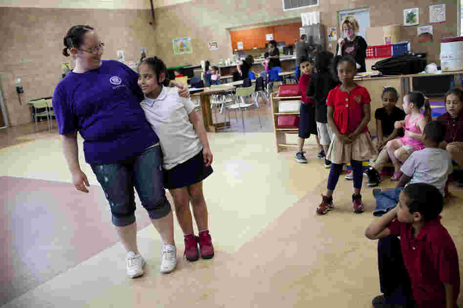 Stepp hugs her daughter, Shyanne, at the Second Street Learning Center, where she is a head assistant teacher earning less than $9 an hour. The center provides 24-hour day care for Reading's working poor and is run by a nonprofit called the Opportunity House.