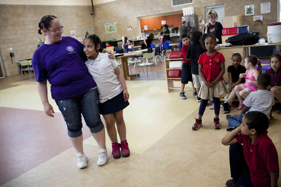 Stepp hugs her daughter, Shyanne, at the Second Street Learning Center, where she is a head assistant teacher earning less than $9 an hour. The center provides 24-hour day care for Reading's working poor and is run by a nonprofit called the Opportunity House.