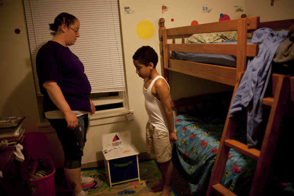 Stepp speaks to Isaiah before bedtime. "Sometimes I think I have done something wrong for them to turn their backs to me," she says of her failed relationships with her children's fathers. "But then there are other times that I'm in a good mood and think, 'Oh, well. Let them go. If they don't want to do it, I can do it. I can be the mother and father at the same time.' "