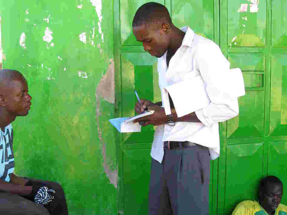 A health worker in western Kenya talks to young men about the benefits of male circumcision.