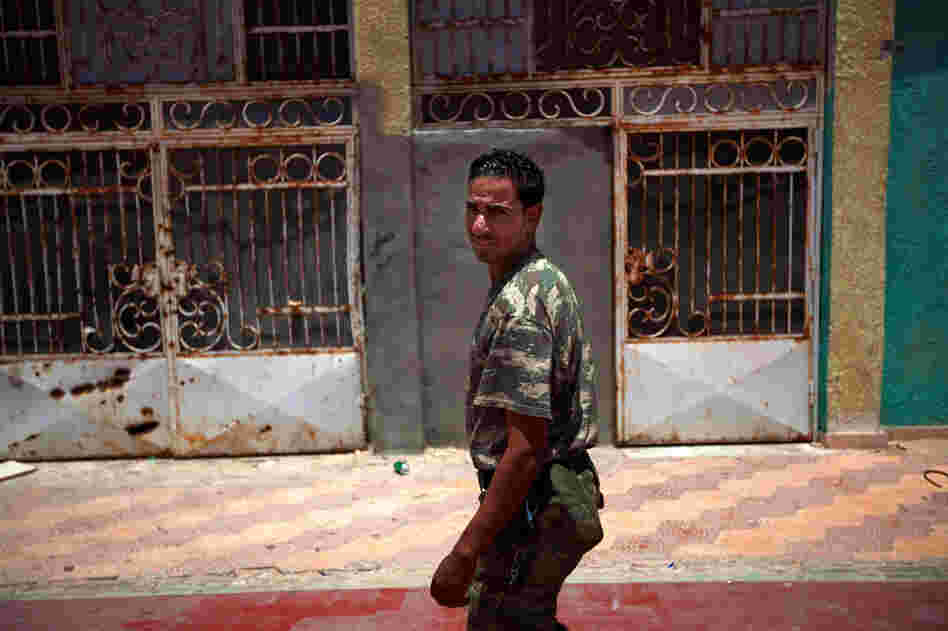 The vice principal at the Okba Bennafee high school, Abdel Mutaleb Suker, is a former rebel who says he started wearing military fatigues to command respect from the students, many of whom come from families loyal to Gadhafi.