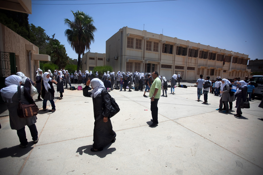 Schoolgirls outside the Martyrs of Libya school near Leptis Magna, Libya. The country's history books are being rewritten, and Gadhafi's rule is now described as a time of corruption and atrocities.