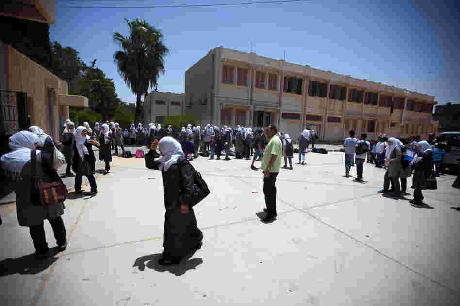 Schoolgirls outside the Martyrs of Libya school near Leptis Magna, Libya. The country's history books are being rewritten, and Gadhafi's rule is now described as a time of corruption and atrocities.