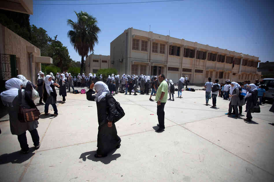 Schoolgirls outside the Martyrs of Libya school near Leptis Magna, Libya. The country's history books are being rewritten, and Gadhafi's rule is now described as a time of corruption and atrocities.