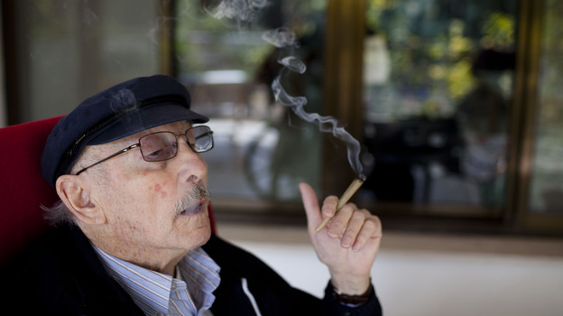 Moshe Rute smokes cannabis at the Hadarim nursing home in Kibutz Naan, Israel. In conjunction with Israel's Health Ministry, the Tikkun Olam company is distributing cannabis for medicinal purposes to more than 1,800 people in Israel.