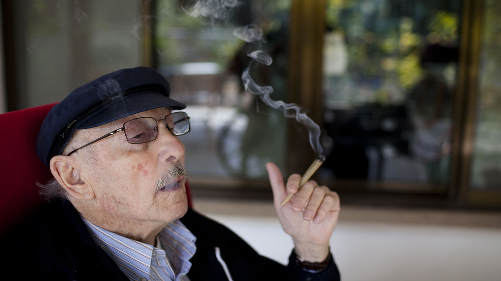 Moshe Rute smokes cannabis at the Hadarim nursing home in Kibutz Naan, Israel. In conjunction with Israel's Health Ministry, the Tikkun Olam company is distributing cannabis for medicinal purposes to more than 1,800 people in Israel.