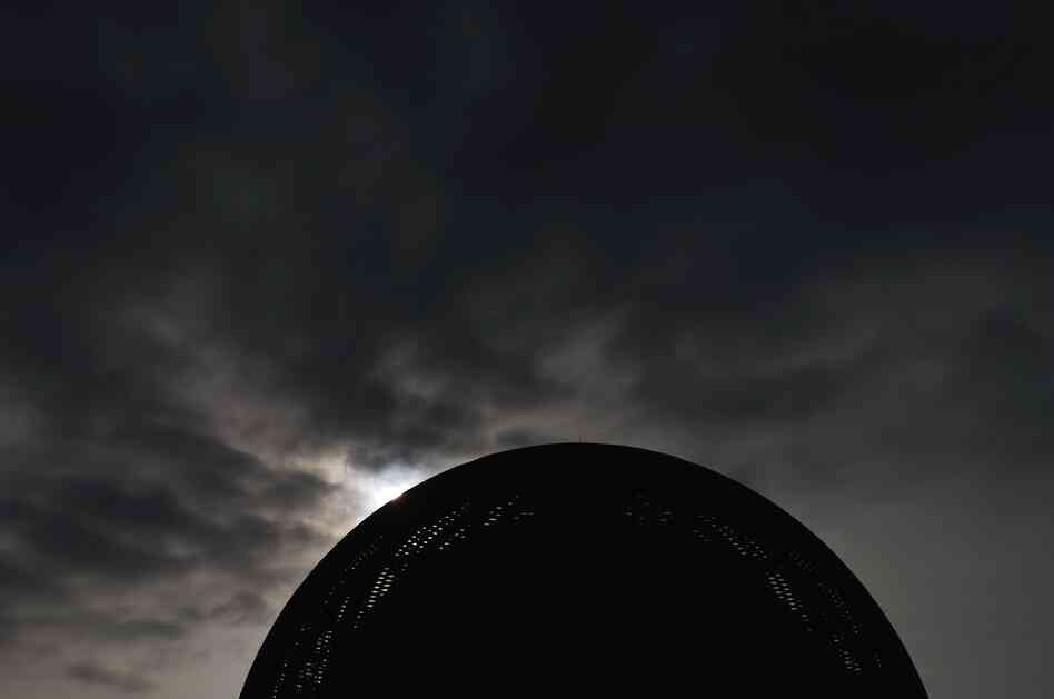 A new day dawning on humanity: the sun rises behind The Globe of Science and Innovation at CERN on July 4, 2012.