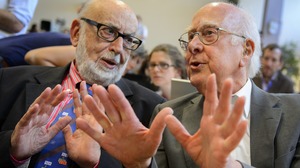 British physicist Peter Higgs (right), who proposed the Higgs boson in the 1960s, speaks with Belgium physicist Francois Englert at Wednesday's event.