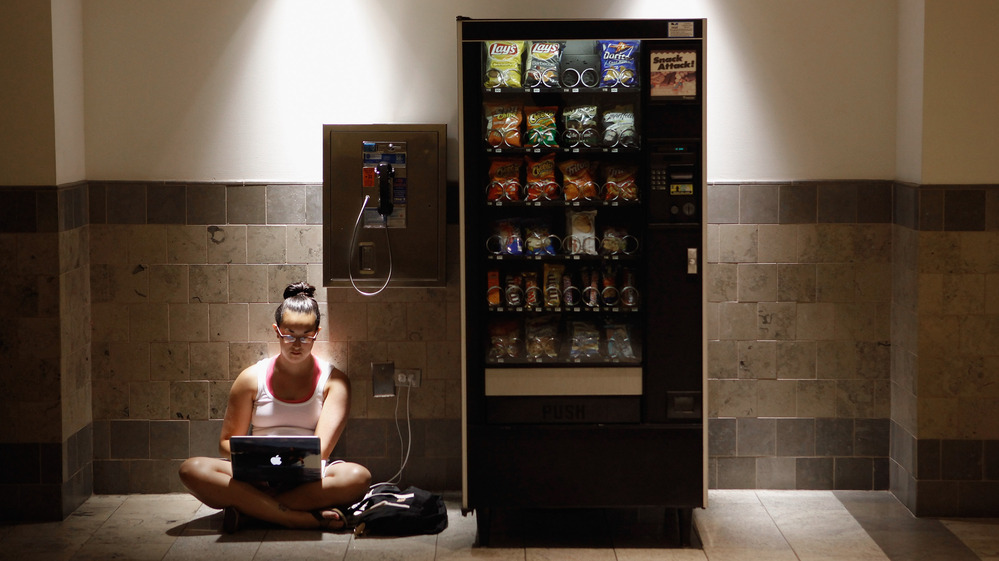 Katie Kiang sits by an electrical outlet and a quiet spot to study  inside the air-conditioned Westfield Montgomery Mall in Bethesda, Md., on Monday.