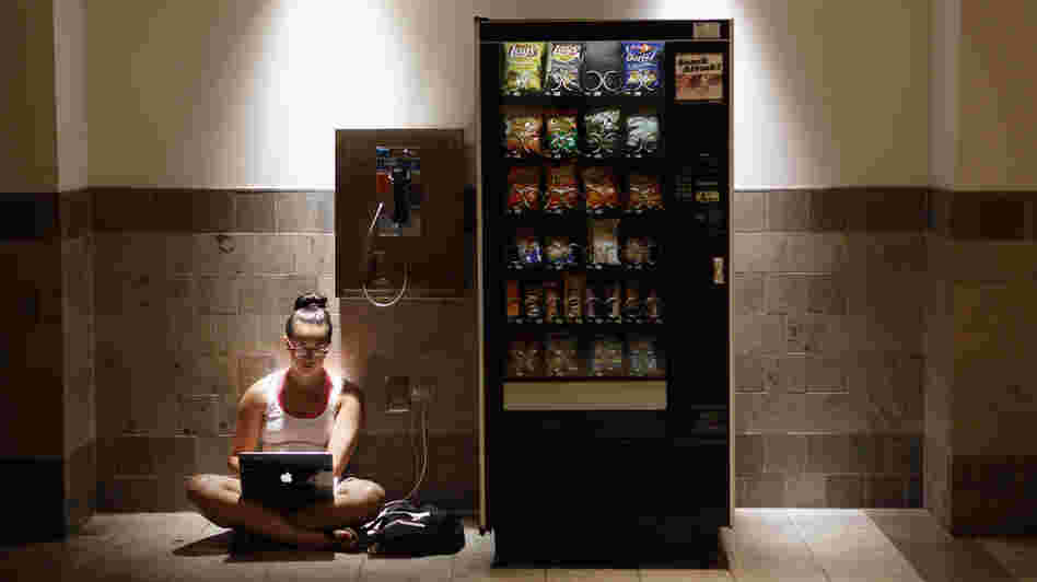 Katie Kiang sits by an electrical outlet and a quiet spot to study  inside the air-conditioned Westfield Montgomery Mall in Bethesda, Md., on Monday.
