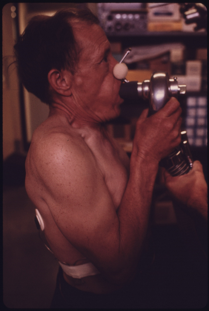 A miner at the black lung laboratory in the Appalachian Regional Hospital in Beckley, W.Va., has his lung capacity tested. Blood samples were also taken and his heartbeat was monitored while walking on a treadmill. These and other tests were used to determine if miners had coal dust particles in their lungs. (Image credit: US National Archives)