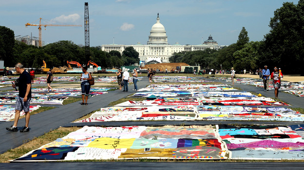 Visitors view the AIDS Memorial Quilt at the National Mall. (NPR)