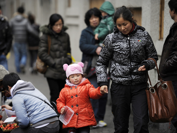 A mother and child walk in Shanghai. China's one-child policy has been in place since 1979. There's now a debate about whether the policy should be eased or dropped.