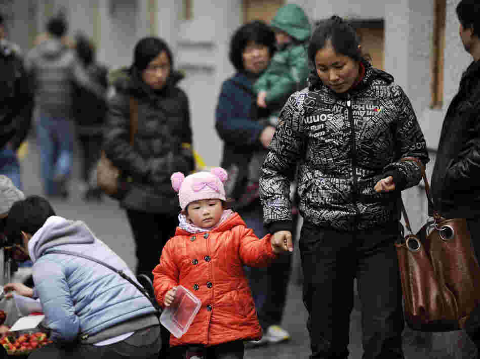 A mother and child walk in Shanghai. China's one-child policy has been in place since 1979. There's now a debate about whether the policy should be eased or dropped.