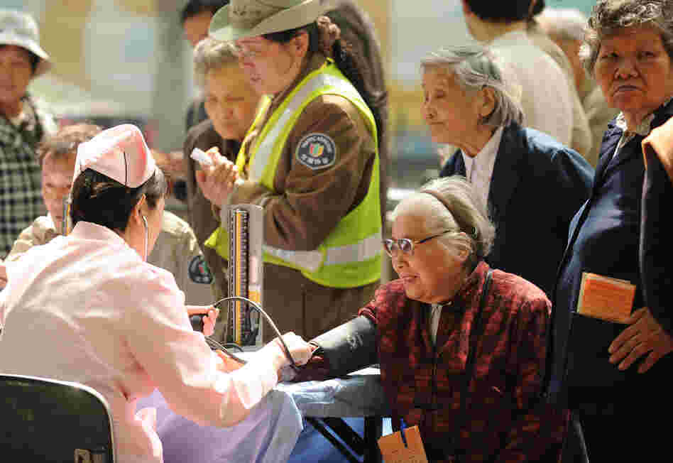 People wait to have their blood pressure checked in Shanghai in April. China's one-child policy is more than just a human rights issue; demographers warn that the low birth rate will result in a shortage of workers to drive the economy. People wait to have their blood pressure checked in Shanghai in April. China's one-child policy is more than just a human rights issue; demographers warn that the low birth rate will result in a shortage of workers to drive the economy.