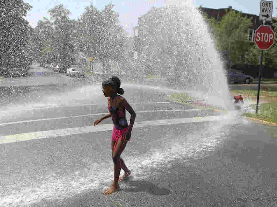 Trying to keep cool in Chicago: On Wednesday, 7-year-old Keshyra Pitts played in the spray from a fire hydrant.