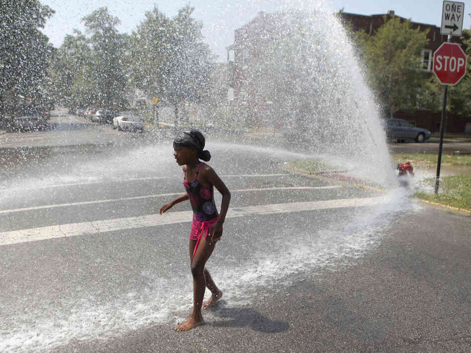 Trying to keep cool in Chicago: On Wednesday, 7-year-old Keshyra Pitts played in the spray from a fire hydrant.